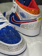 Nike sneakers with colorful rhinestone embellishments on a white background