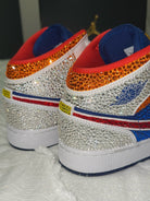 Pair of crystal embellished mid sneakers with blue, red, and white design on a textured white background